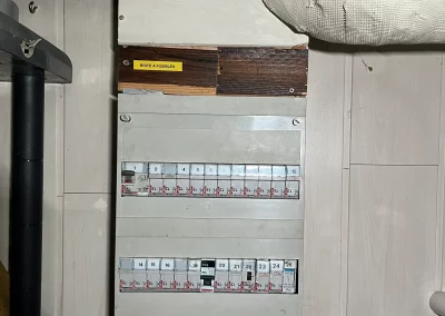 Ancien tableau électrique à porte-fusibles vétuste et non conforme, avant son remplacement dans une maison à Dreux.